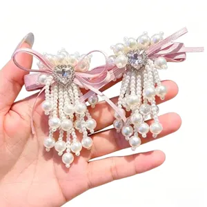 Pearl bow hair clip detail showing Korean style hairpin with beaded fringe and heart crystal.