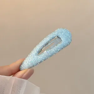 Blue rhinestone waterdrop hair clip sparkle snap hair accessory for women styling side bangs.