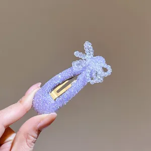 Purple glitter hairpin detail, sparkling beaded bow design on a sturdy metal BB clip.