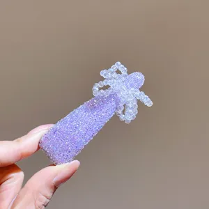 Detailed close-up of a stylish Korean purple rhinestone and beaded bow hair clip accessory.