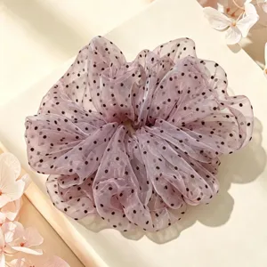 Close-up view of elegant polka dot mesh hair scrunchie detail for cute hair styling.