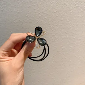 Exquisite crystal flower hair tie with multi strands, elegant black ponytail holder accessory.