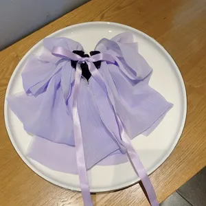Elegant purple chiffon hair claw clip with long ribbon large bow design for women ponytail.