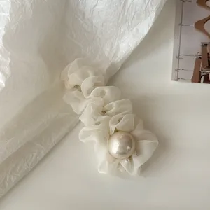 Detailed close-up of Korean style white mesh hair clip featuring a large elegant faux pearl.