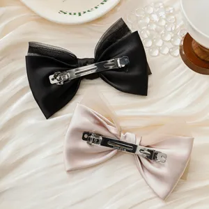 Double-layer bow hair clip detail shot, satin and organza design with metal barrette.