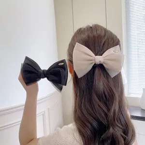 Detailed view of the elegant double-layer organza bow hair clip, showcasing fine texture.