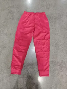 Detailed view of pink brushed suede joggers with elastic drawstring waist and cuffed hem.
