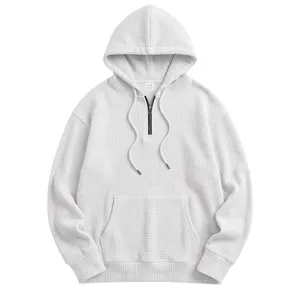 Detailed view of white waffle knit quarter-zip hoodie texture and metal zipper design.
