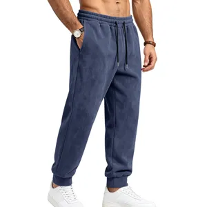 Detail view of men's fleece-lined suede sweatpants with elastic drawstring waist and cuffed hem.