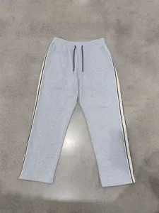 Grey wide-leg sweatpants with side stripes, comfortable knit fabric and drawstring waist.