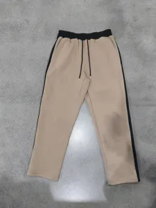 Details of men's heavyweight fleece-lined sweatpants with contrast side stripes and drawstrings.