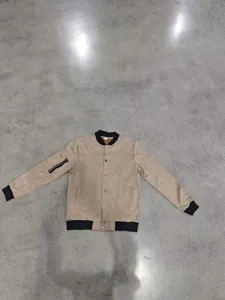 Detail view of men faux suede bomber jacket with ribbed cuffs, snap button and sleeve zip pocket.
