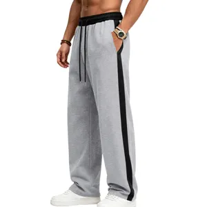 Detail view of men's fleece-lined loose sweatpants with contrast side stripes.
