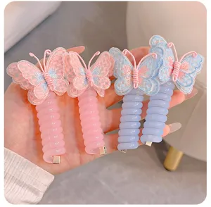 Closeup detail view of cute pastel pink and blue telephone wire hair ties with embroidered butterfly.