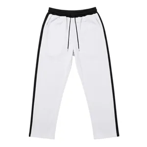 Detailed view of the white loose casual sweatpants with black side stripes, knitted fabric.
