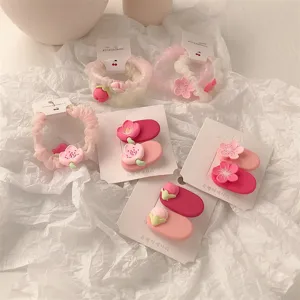 Sweet pink floral hair clips and cute scrunchies set, lovely fashion hair accessories detail.