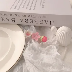 Close-up detail of a sweet pink and white floral hair clip, cute aesthetic hair accessory.