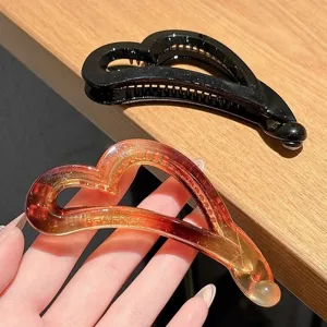 Heart-shaped banana hair clip for stylish ponytails and half-up hairstyles, durable resin claw.