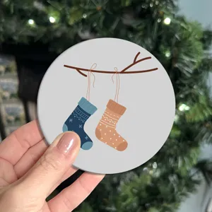 Cute round car coaster with winter socks pattern, anti-slip rubber mat for desktop use.