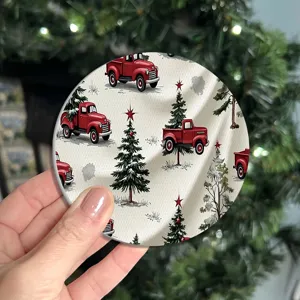 Round Christmas coaster with vintage red truck and tree pattern, perfect for holiday table decor.