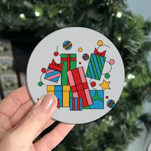 Detailed close-up of a colorful cartoon gift box pattern round soft rubber coaster.