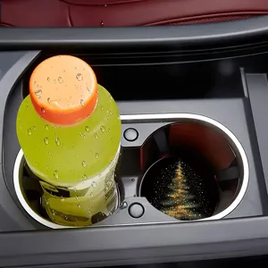 Close-up detail view of the festive Christmas tree car cup coaster in vehicle holder.