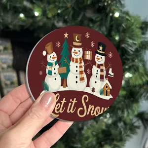 Round Christmas coaster with cute snowman design detail view for festive table decoration.