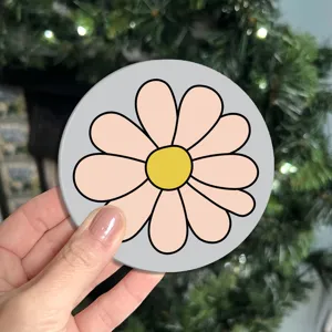 Close-up detail of a charming round pink flower silicone coaster with grey background for table decor.