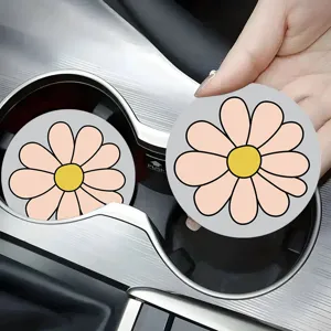 Silicone car cup holder coaster detail showing cute pink daisy floral print design.