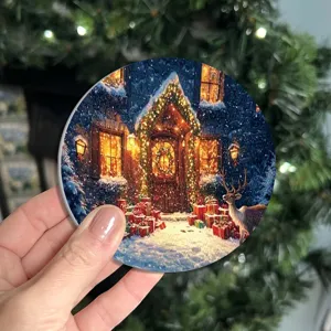 Close-up detail of a round Christmas winter scene absorbent ceramic drink coaster for home decor.