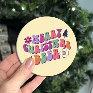 Close-up detail shot of a retro Christmas themed round cup coaster with festive text and design.