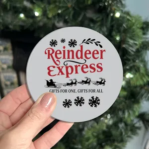 Detailed close-up of a grey round car cup coaster featuring Christmas reindeer and snowflake graphics.