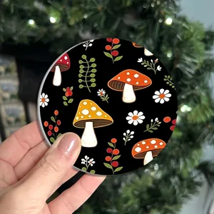 Detailed view of a round silicone coaster featuring a cute botanical mushroom and floral print.