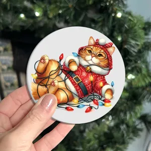 Handmade Christmas cat themed round coaster with festive lights illustration detail.