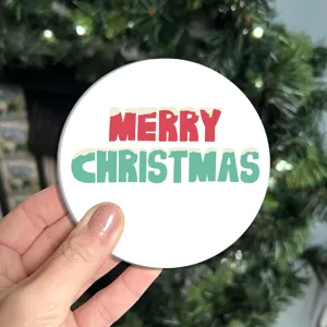Christmas round coaster with festive red and green typography print for holiday table decor