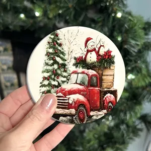 Detailed close-up of a round Christmas themed coaster featuring a vintage red truck and snowmen.