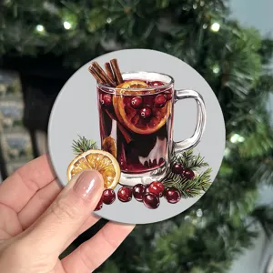 Close-up detail of a festive Christmas mulled wine design round drink coaster in a cozy setting.