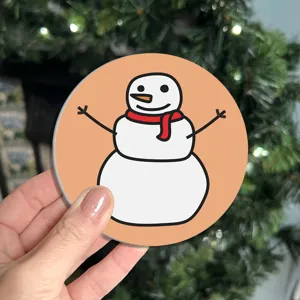 Cute cartoon snowman car coaster detail shot, non-slip cup holder mat for vehicle interior.