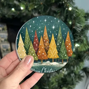 Round ceramic Christmas coaster with watercolor tree pattern, absorbent and heat-insulating cup mat.