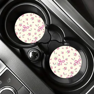 Detail view of silicone car cup coasters with cute pink bow and floral pattern for drinks.