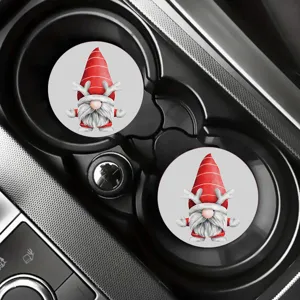 Car cup holder detail showing two round Christmas gnome coasters with red hat and reindeer antlers.