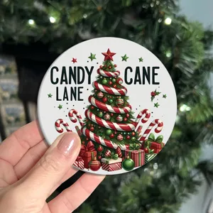Close-up detail of a festive round Christmas coaster featuring candy cane tree print.