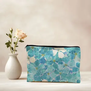 Detailed view of portable zipper makeup bag featuring elegant blue watercolor floral print.