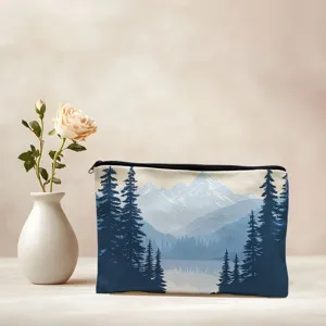 Portable canvas makeup bag with blue mountain and pine tree landscape print for travel.