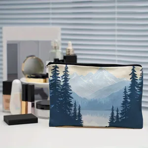 Canvas cosmetic pouch detail showing scenic mountain and pine tree print with durable zipper.