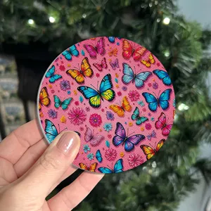 Detailed view of the absorbent ceramic coaster featuring colorful butterfly and flower print.