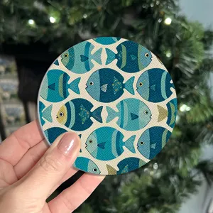 Absorbent ceramic coaster with blue fish pattern, non-slip tea coffee cup mat detail view.