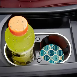 Detailed view of car cup holder coaster featuring blue fish pattern non-slip design.