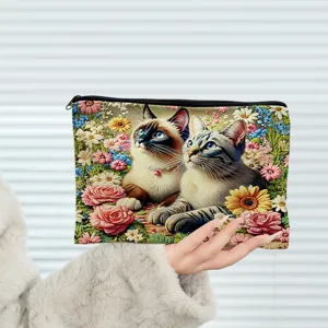 Canvas cosmetic bag with cute cat floral print, convenient zippered makeup pouch detail.