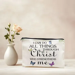 Canvas makeup pouch detail view with inspirational text print and delicate butterfly motifs.